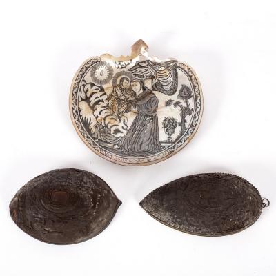 Appraisal: Two profusely carved coconut shell halves and a shell carved