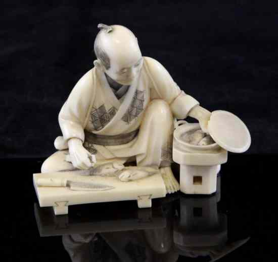 Appraisal: A small Japanese ivory okimono of a man preparing cooked