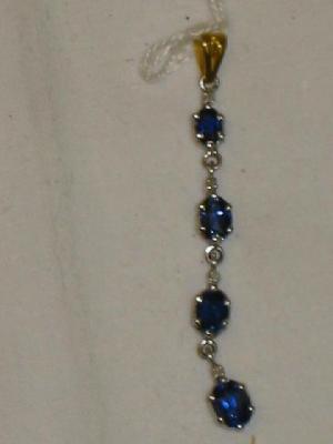 Appraisal: A PENDANT with four sapphire drops in white metal setting