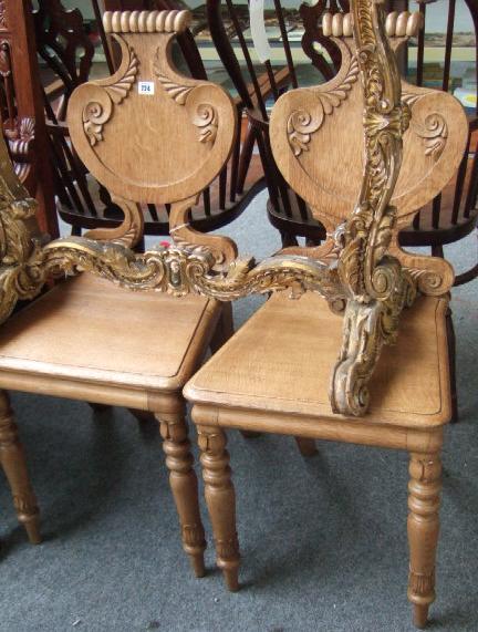 Appraisal: A pair of mid Victorian oak hall chairs the lozenge