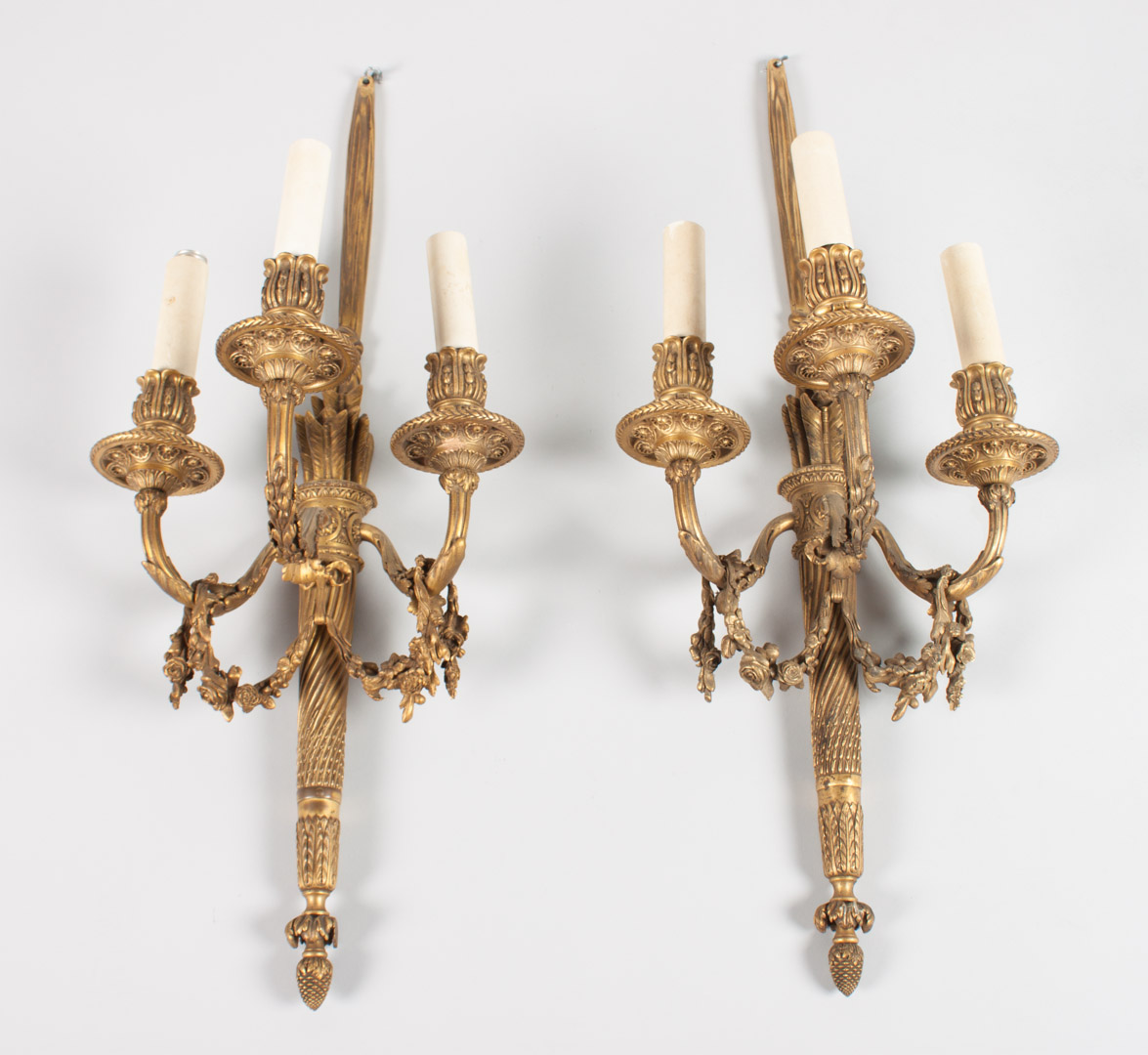 Appraisal: Pair of Louis XVI style bronze sconces three-light sconces in