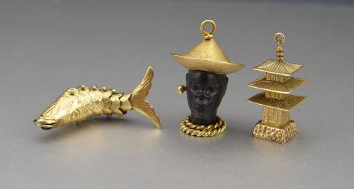 Appraisal: GOLD CHARMS Pagoda marked K '' grams Articulated Fish marked