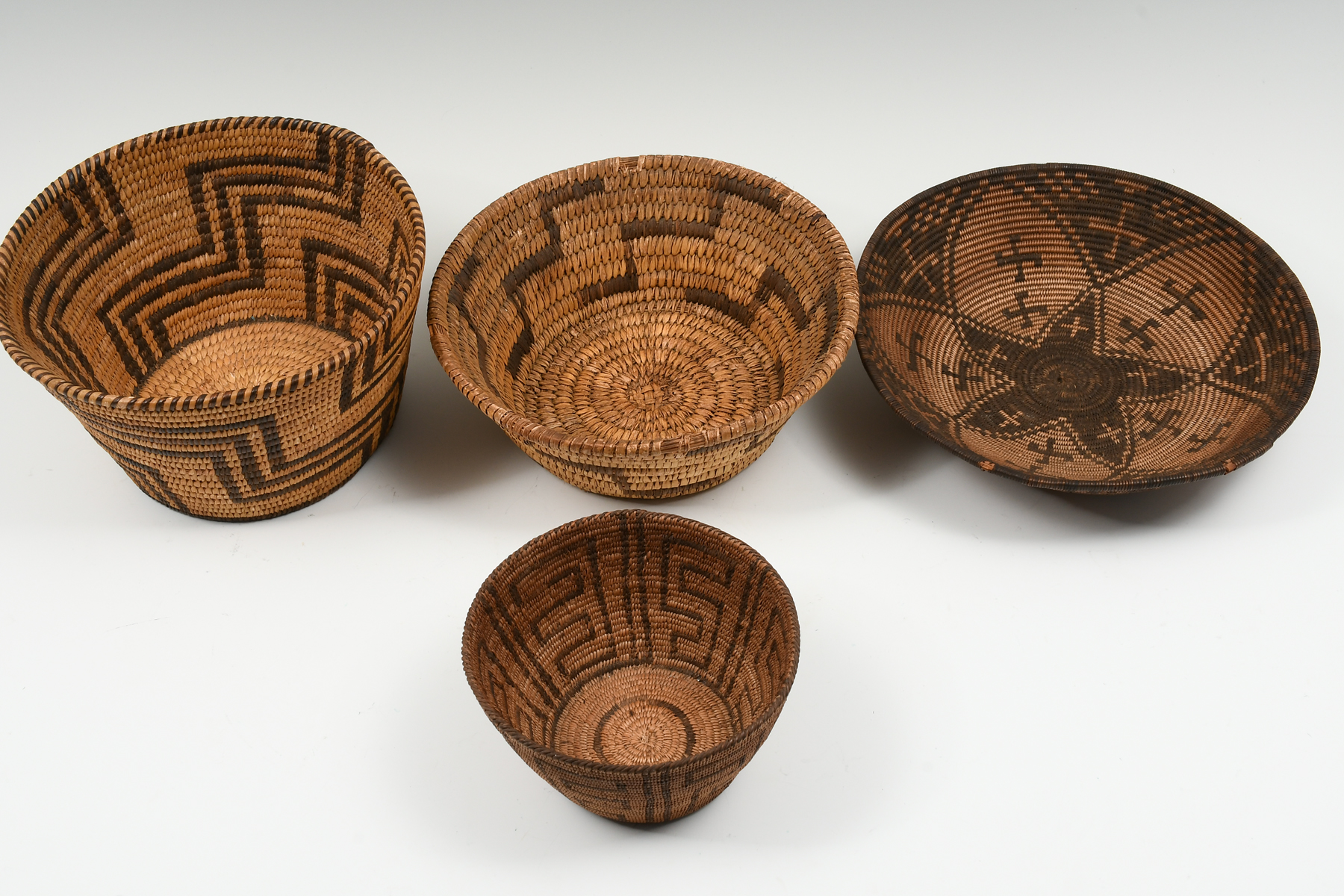 Appraisal: PC NATIVE AMERICAN WOVEN BASKETS Comprising - with Geometrical designs