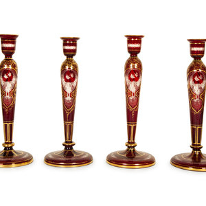 Appraisal: A Set of Four Bohemian Ruby Cut-to-Clear Glass Candlesticks with