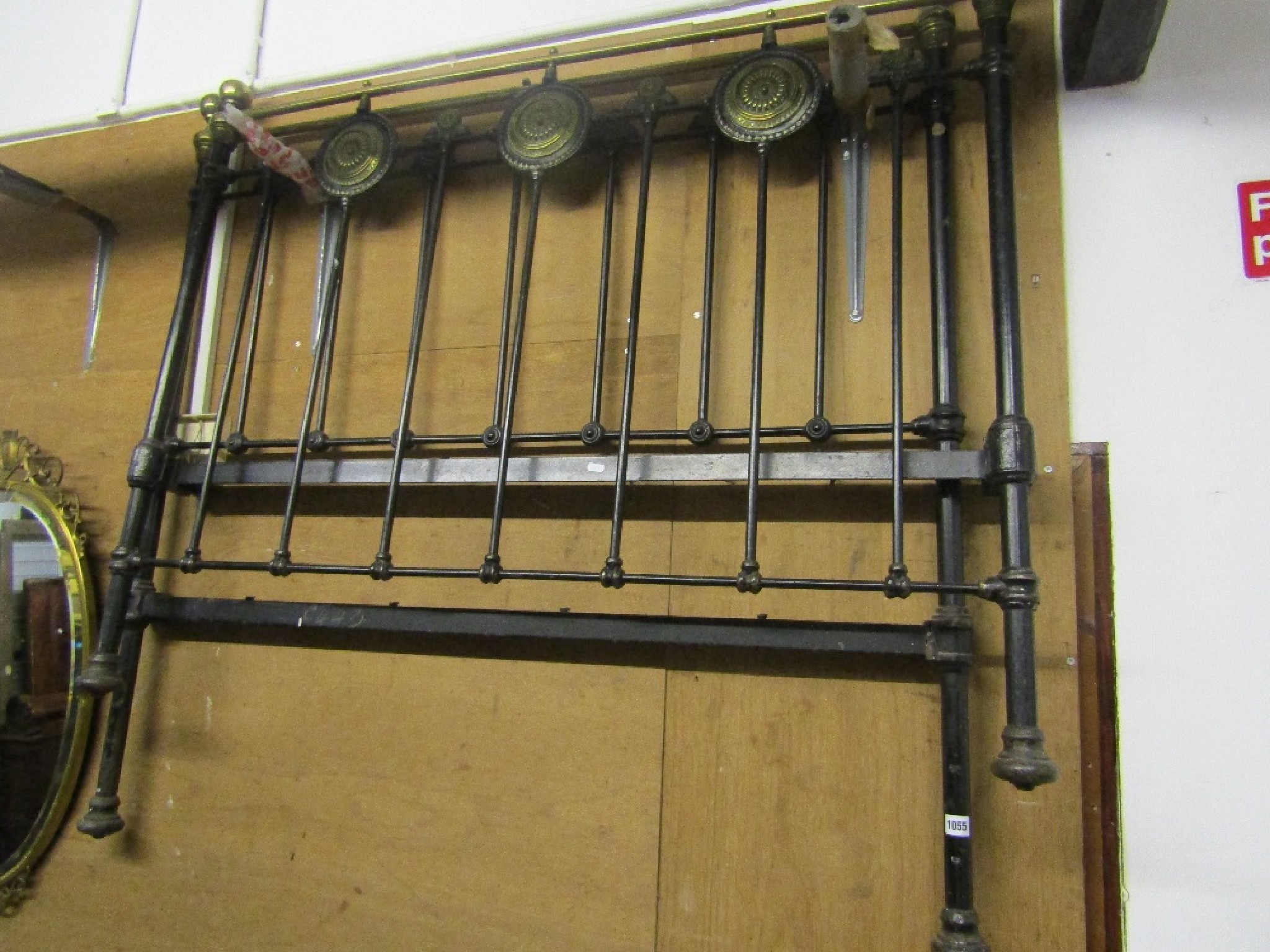 Appraisal: A Victorian cast iron double bedstead with decorative brass rosettes