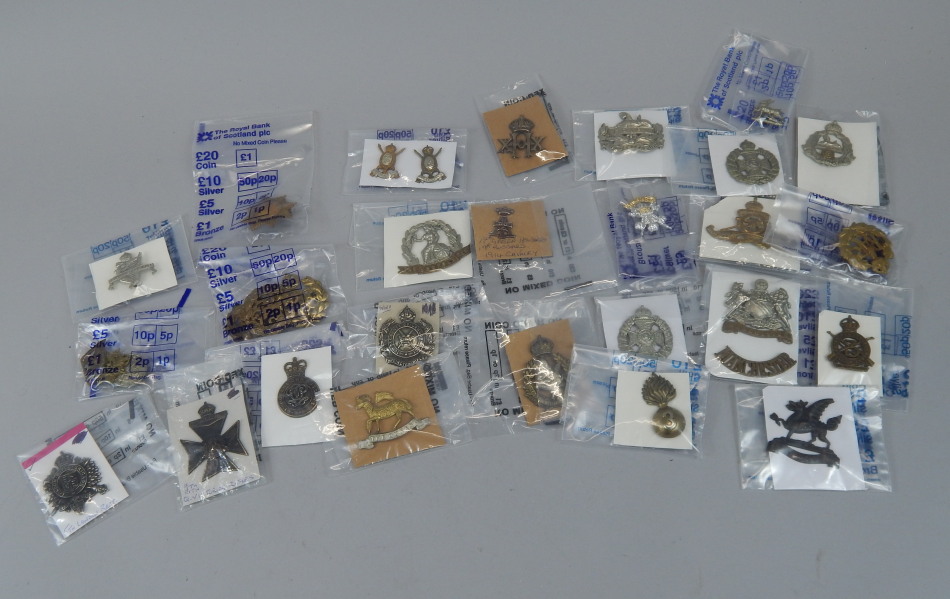 Appraisal: A quantity of military cap badges to include Manchester Regiment