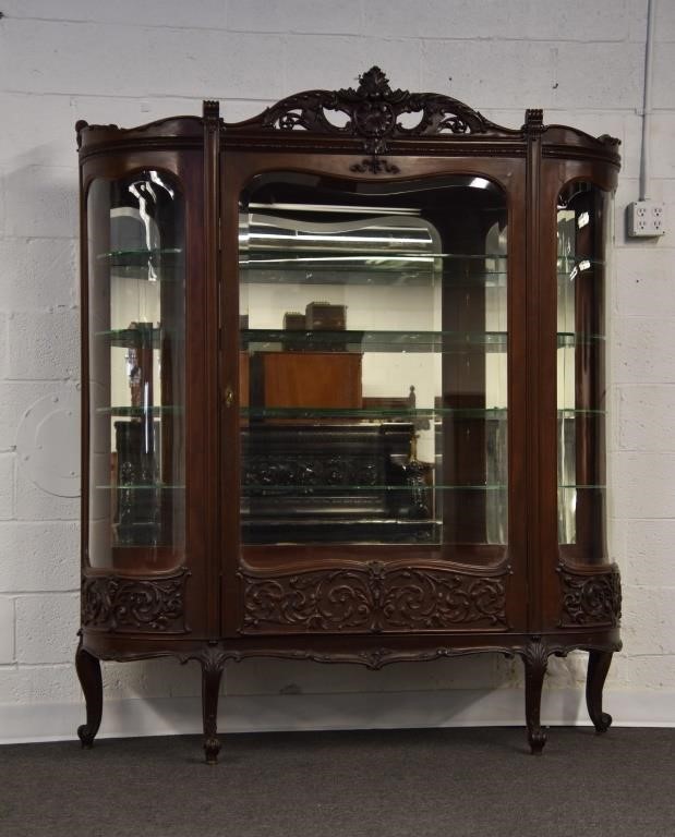 Appraisal: Mahogany china closet with ornate carvings and beveled glass late