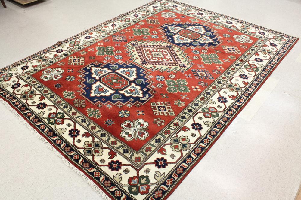 Appraisal: HAND KNOTTED ORIENTAL CARPET Indo-Persian three geometric medallions and surrounding