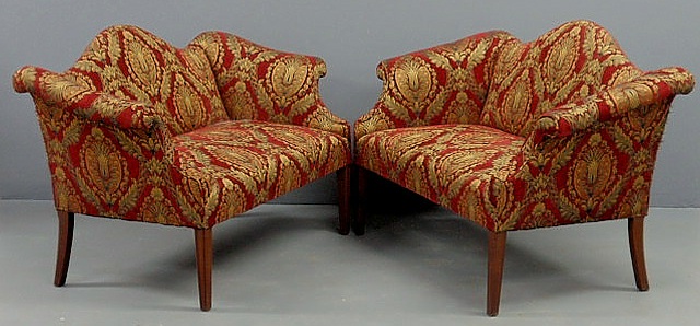 Appraisal: Pair of Chippendale style mahogany camelback settees one is an