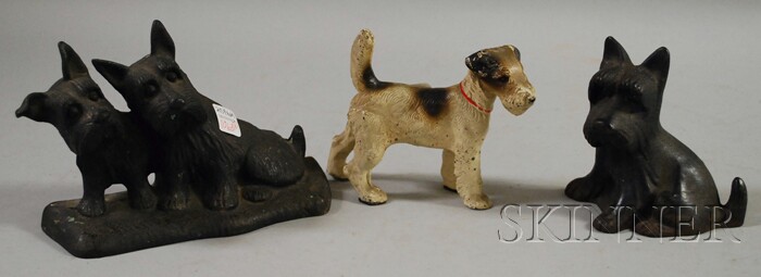 Appraisal: Three Cast Iron Dog Doorstops early th century a terrier