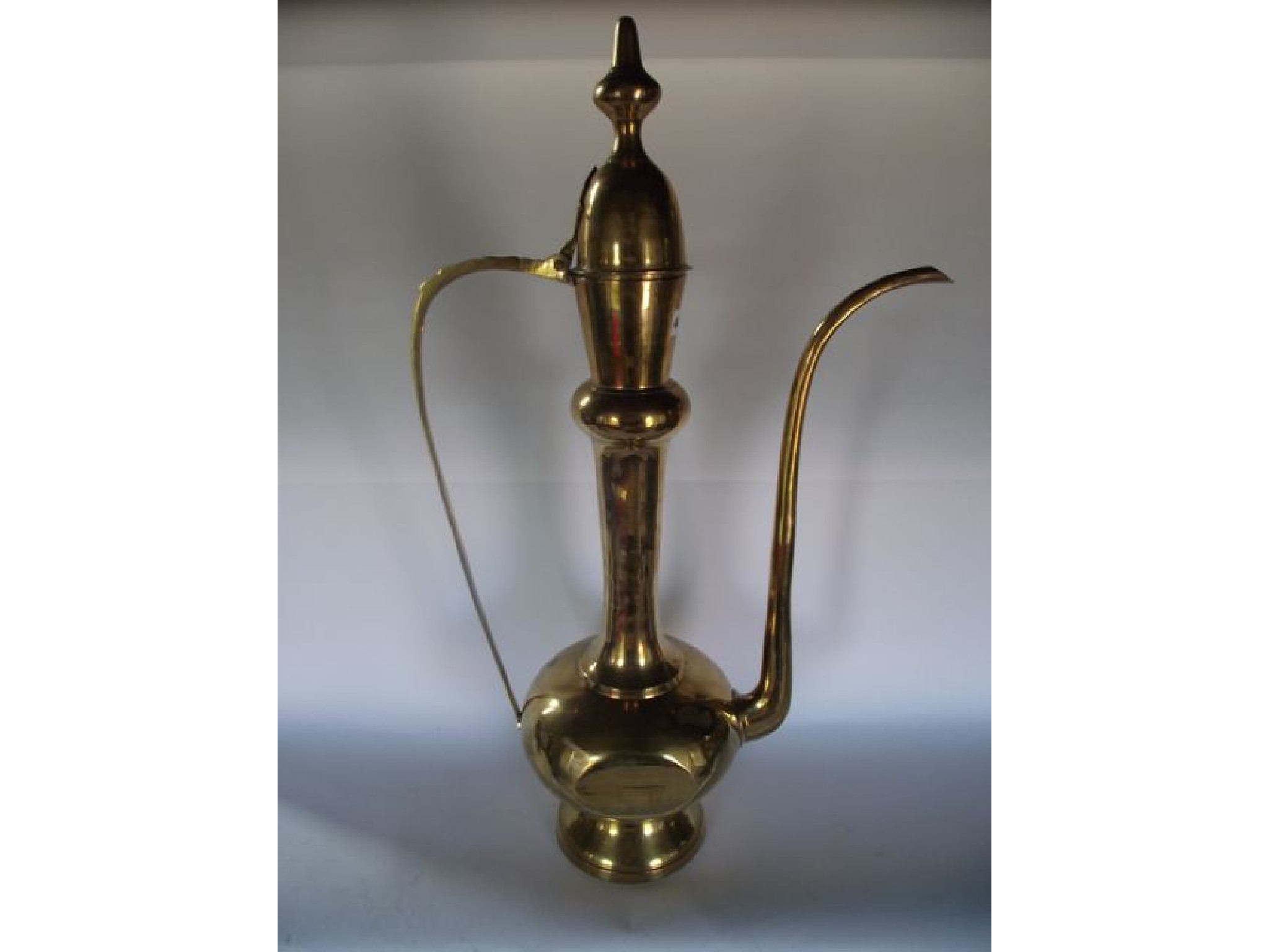 Appraisal: A substantial eastern brass ewer possibly Turkish with a hinged