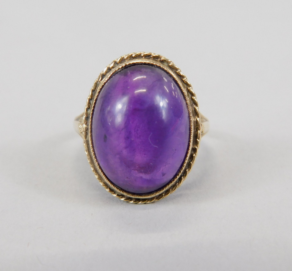 Appraisal: A ct gold dress ring the central purple oval glass