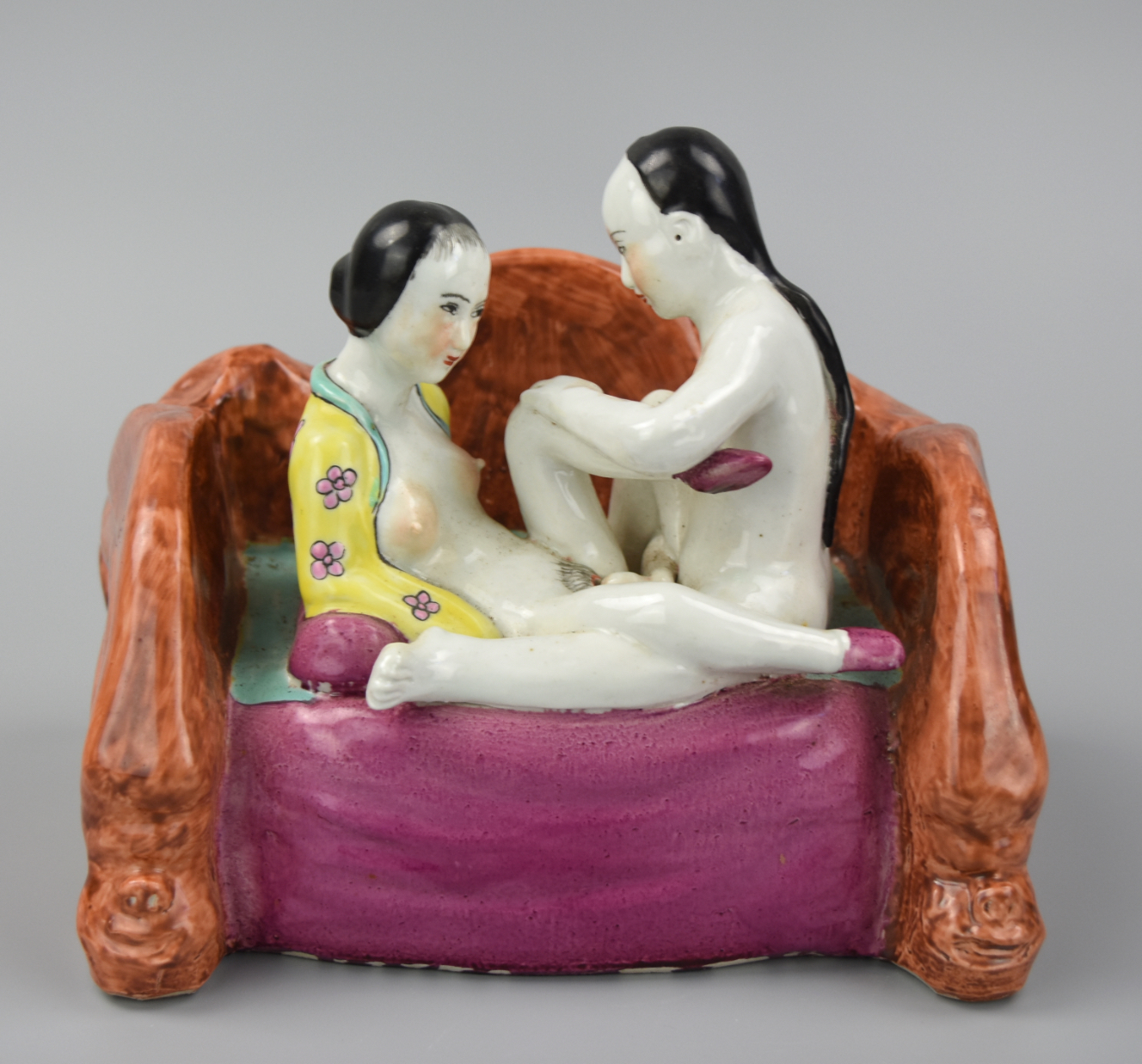 Appraisal: EROTIC CHINESE FAMILLE ROSE FIGURES ON LOVE SEAT An th