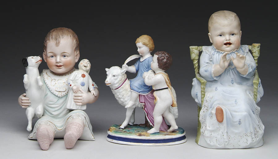 Appraisal: THREE DECORATED FIGURINES OF CHILDREN h figure of a baby