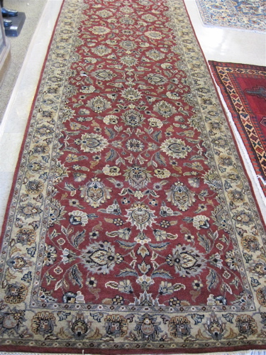 Appraisal: HAND KNOTTED ORIENTAL CARPET Indo-Persian having a floral decorated madder