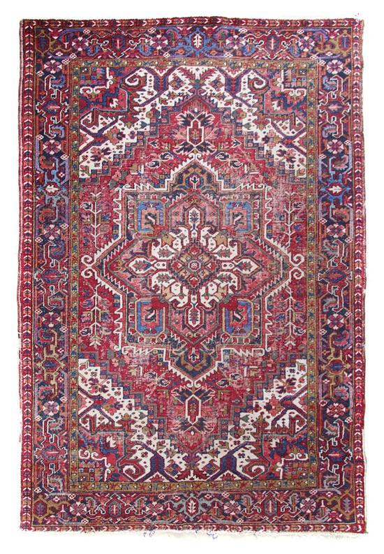 Appraisal: Heriz Wool Carpet having stylized foliate center medallion within triple