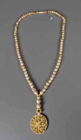 Appraisal: Chinese Carved Ivory Beaded Necklace PendantThe pendant carved to depict