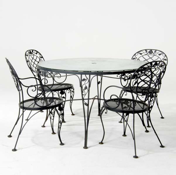 Appraisal: WOODARD Patio set including a dining table with hammered glass