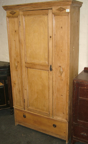 Appraisal: A French pine wardrobe the moulded cornice above panelled door