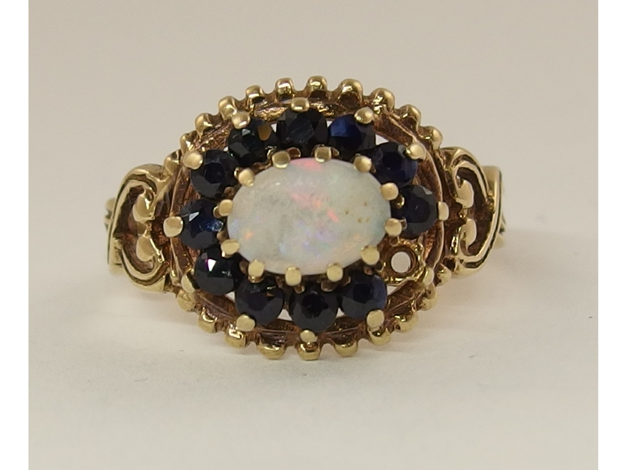 Appraisal: A ct sapphire and opal cluster ring