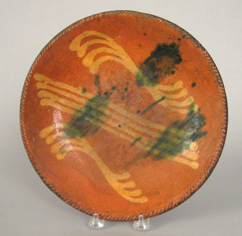 Appraisal: Redware charger th c with yellow slip and green splash