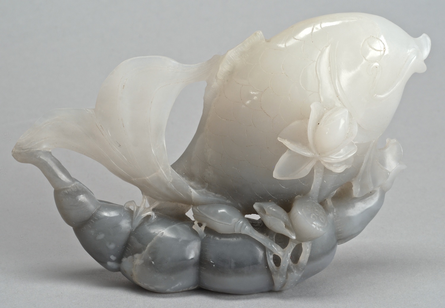 Appraisal: CHINESE BLACK AND WHITE JADE CARVING depicting a fan-tailed carp