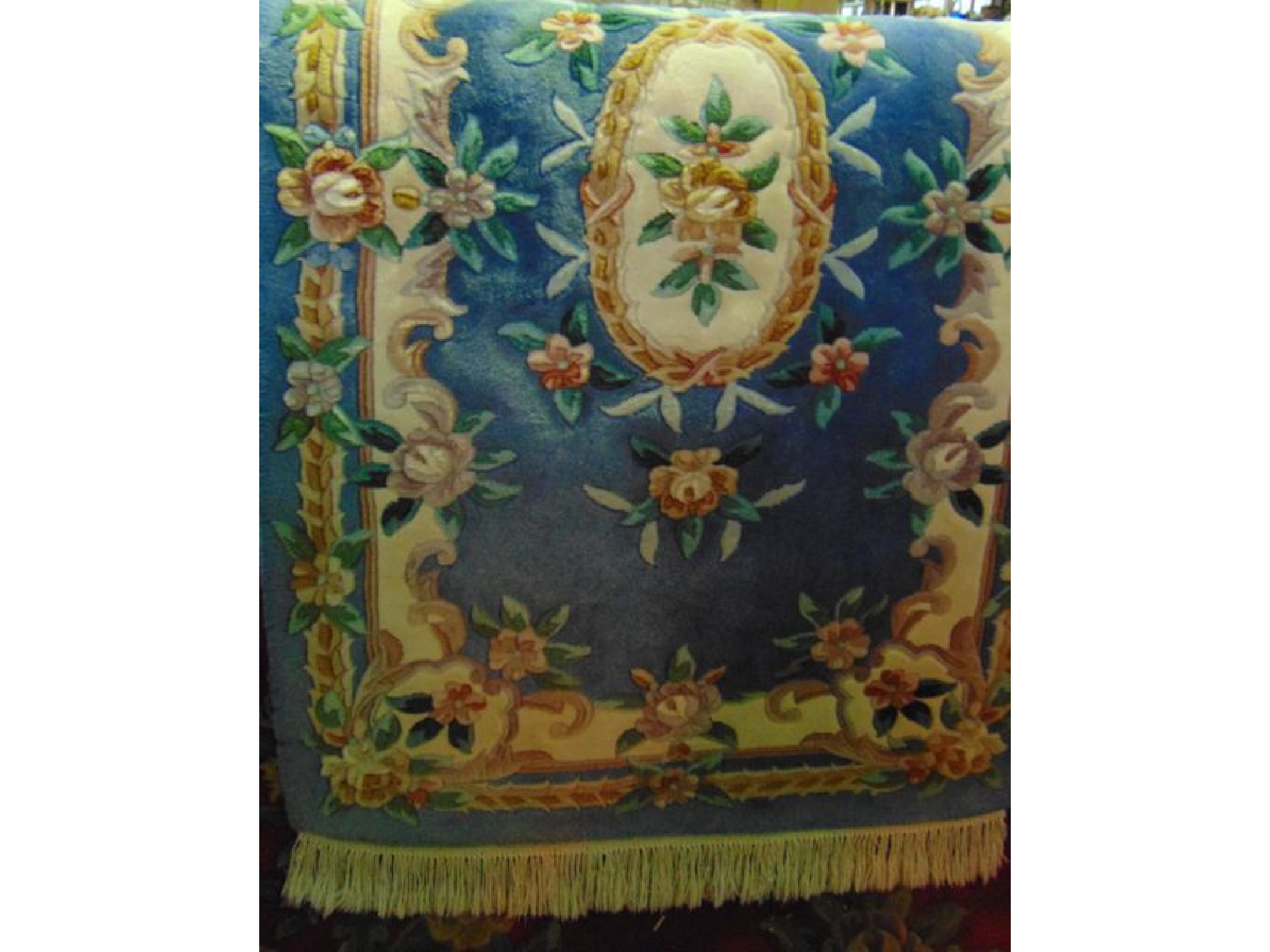 Appraisal: A small Chinese wash wool rug on blue ground with