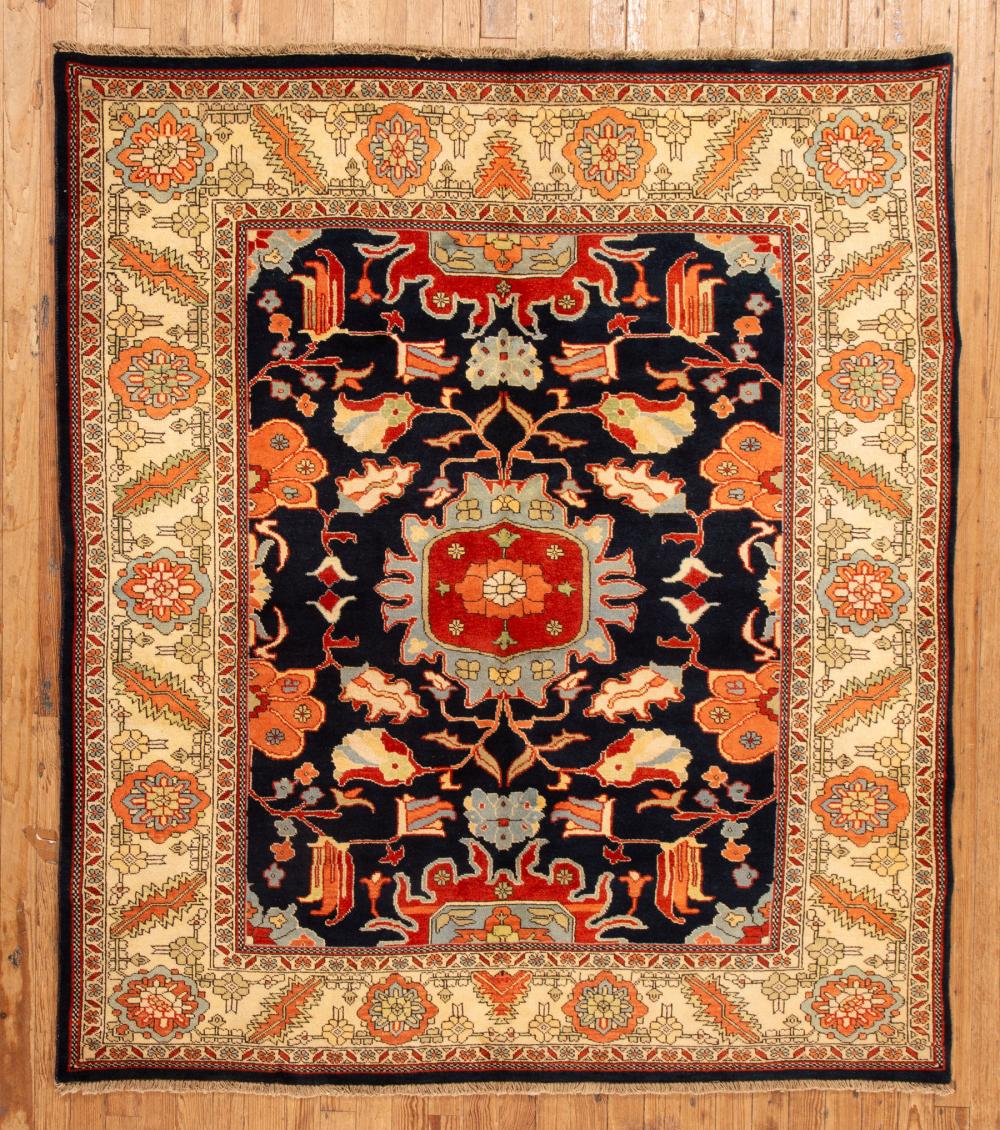 Appraisal: Persian Serapi Carpet dark blue and cream ground stylized foliate