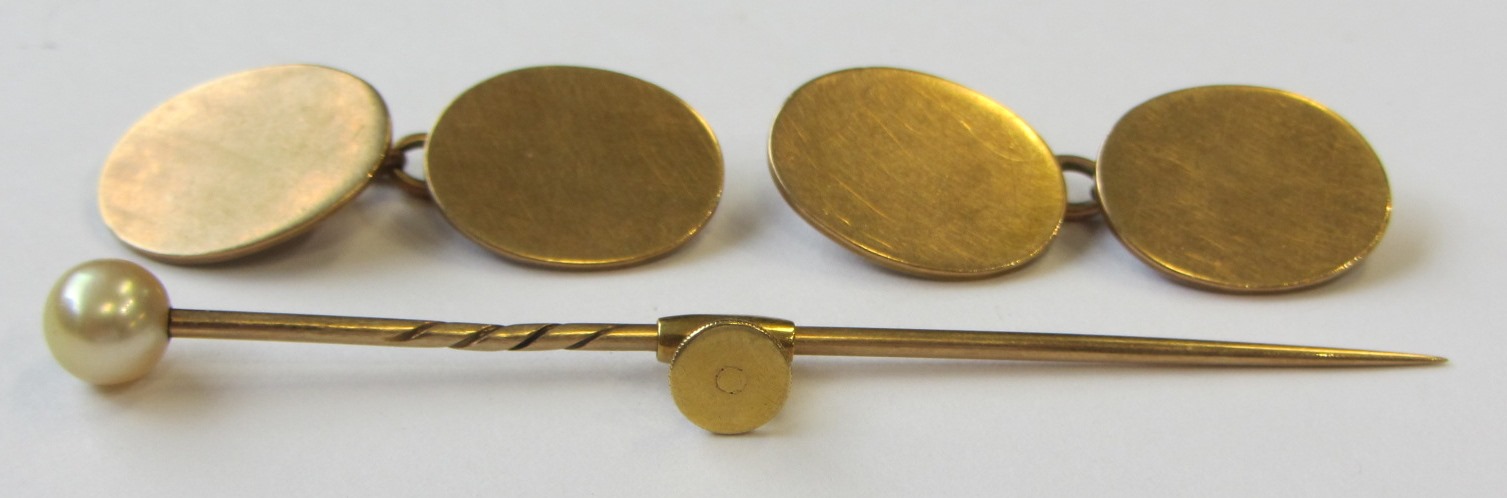 Appraisal: A pair of gold cufflinks the plain oval backs and