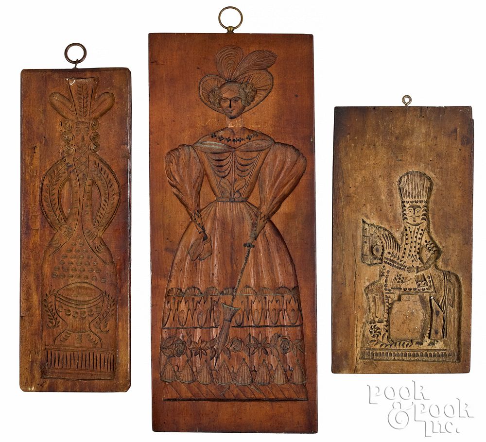 Appraisal: Three carved cakeboards th c with figural dec Three carved