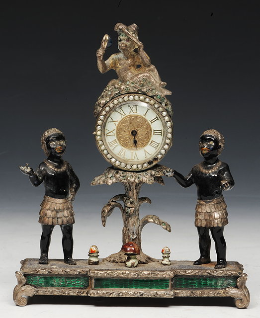 Appraisal: A SMALL SILVERED METAL AND ENAMEL MANTEL CLOCK in the