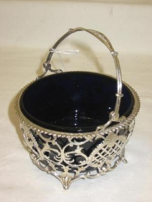 Appraisal: AN EDWARDIAN SUGAR BOWL of circular form with swing loop