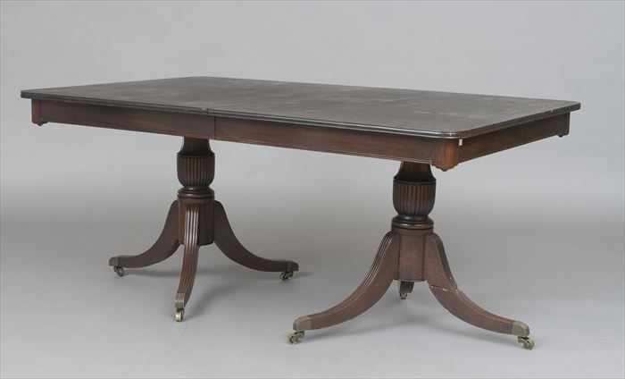 Appraisal: REGENCY-STYLE CARVED MAHOGANY TWO-PEDESTAL EXTENSION DINING TABLE The rectangular top