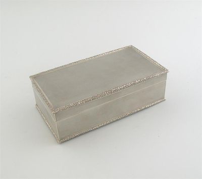 Appraisal: A modern oblong cigarette box with engine turning raised floral