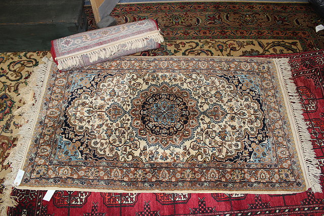 Appraisal: AN INDO PERSIAN CREAM GROUND SMALL RUGS with dense field