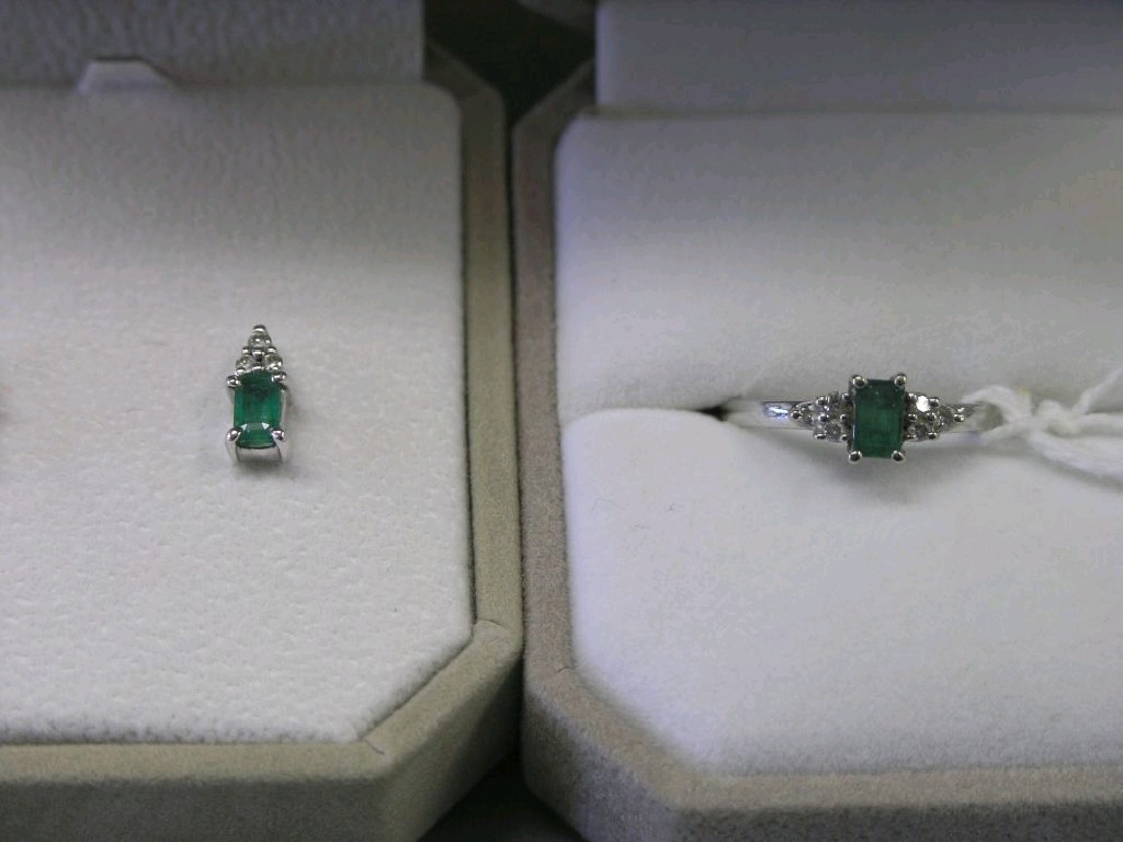 Appraisal: A ct white gold diamond and emerald ring and pair