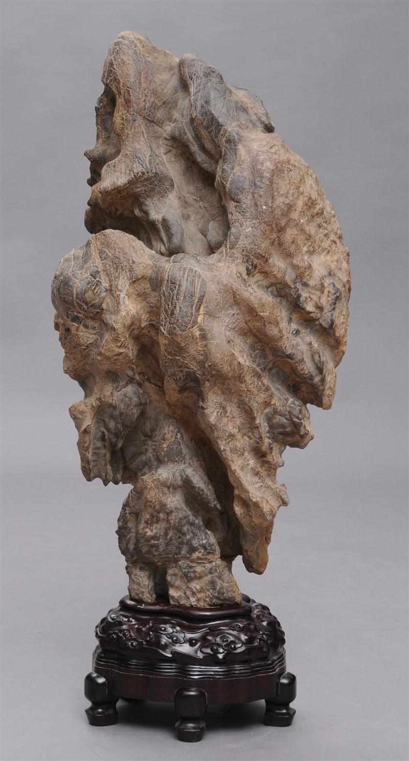 Appraisal: CHINESE MOTTLED PINK SCHOLAR'S ROCK Of naturalistic form on hardwood