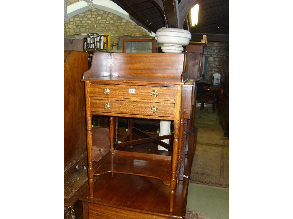 Appraisal: A th century mahogany washstand with raised back above two