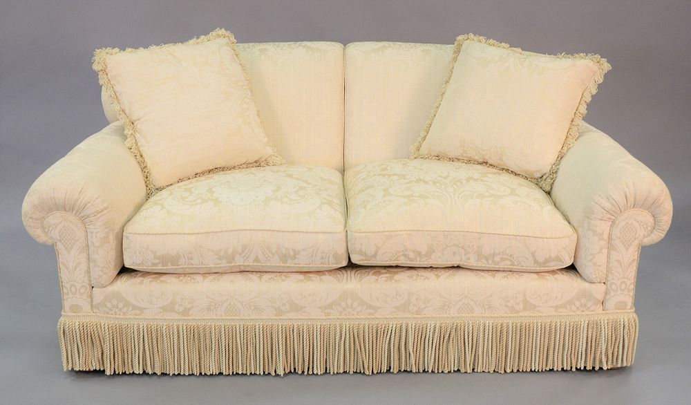 Appraisal: Custom two cushion white sofa tassel details to the base