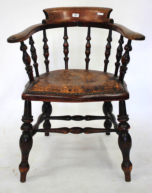 Appraisal: A LATE TH CENTURY SMOKERS BOW ARMCHAIR with leather upholstered