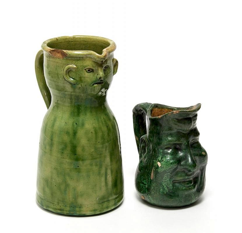 Appraisal: Folk Art Green-Glazed Pottery Face Jugs Rare antique face jugs