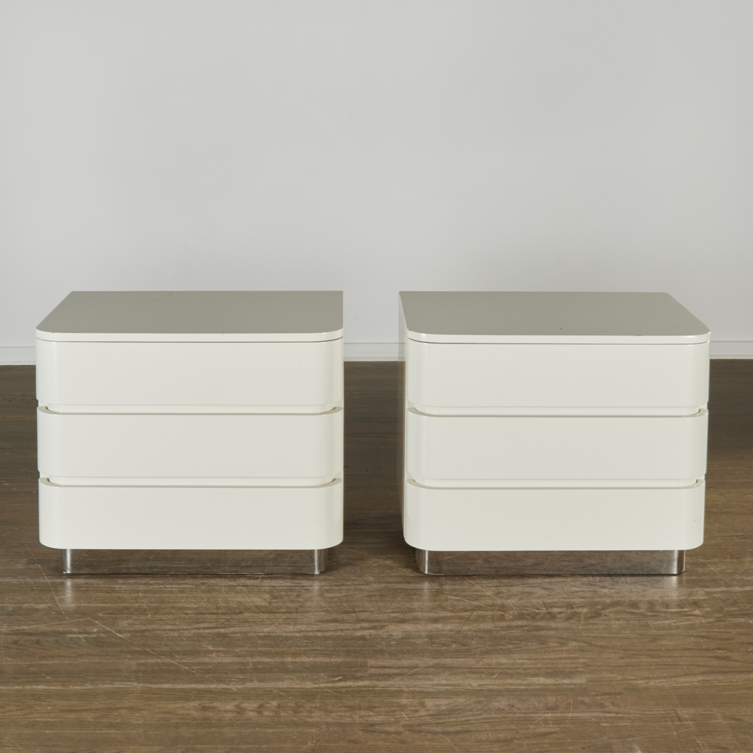 Appraisal: PAIR KARL SPRINGER WHITE LACQUERED NIGHT STANDS th c D-shaped