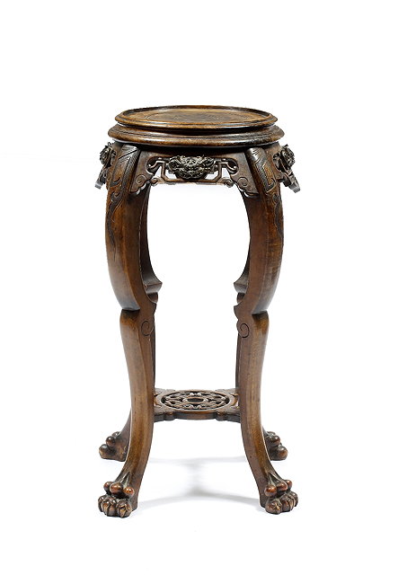 Appraisal: A Chinese hardwood urn standcircular top and carved frieze on