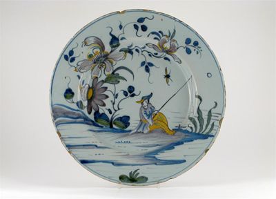 Appraisal: A Delftware charger probably Liverpool painted with a fisherman before