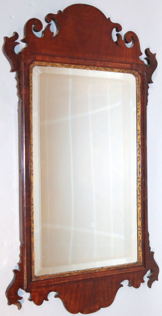 Appraisal: A thC walnut framed pier glass the shaped scroll frame