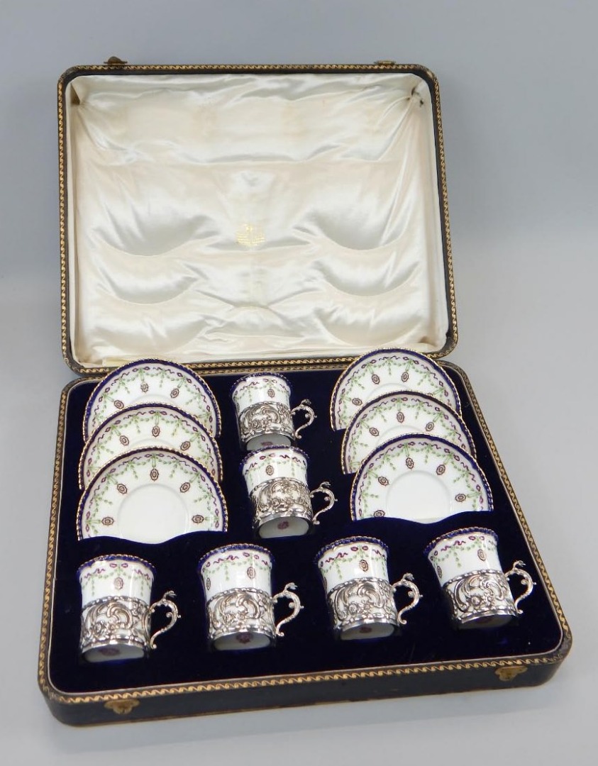 Appraisal: An Edwardian Royal Worcester porcelain coffee service with embossed silver