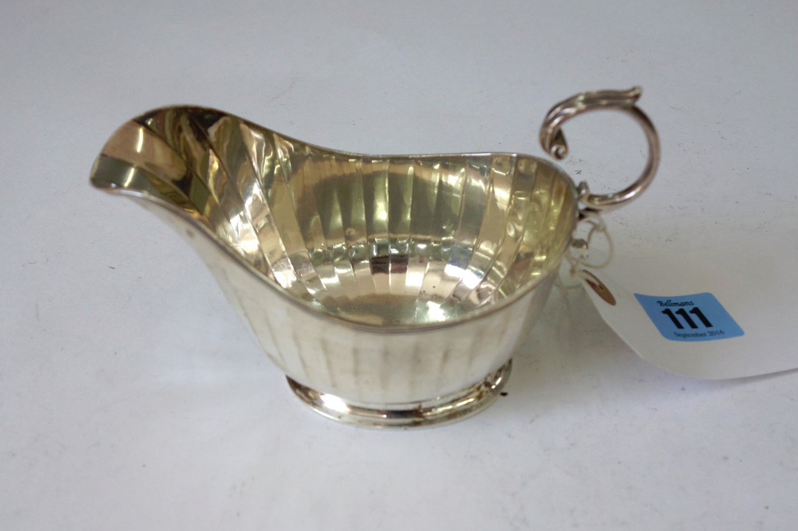 Appraisal: A silver helmet shape sauce boat and a silver Georgian