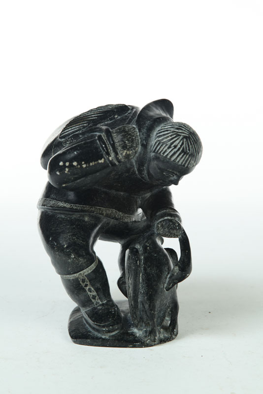 Appraisal: CARVED INUIT FIGURE Twentieth century black soapstone Hunter with goose