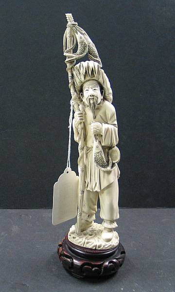 Appraisal: A tinted ivory fisherman The surfaces highlighted with black wash