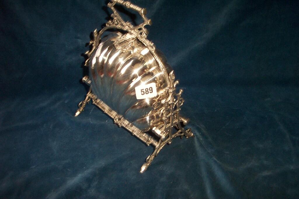 Appraisal: A silver-plated folding warming dish with rustic stand and handle